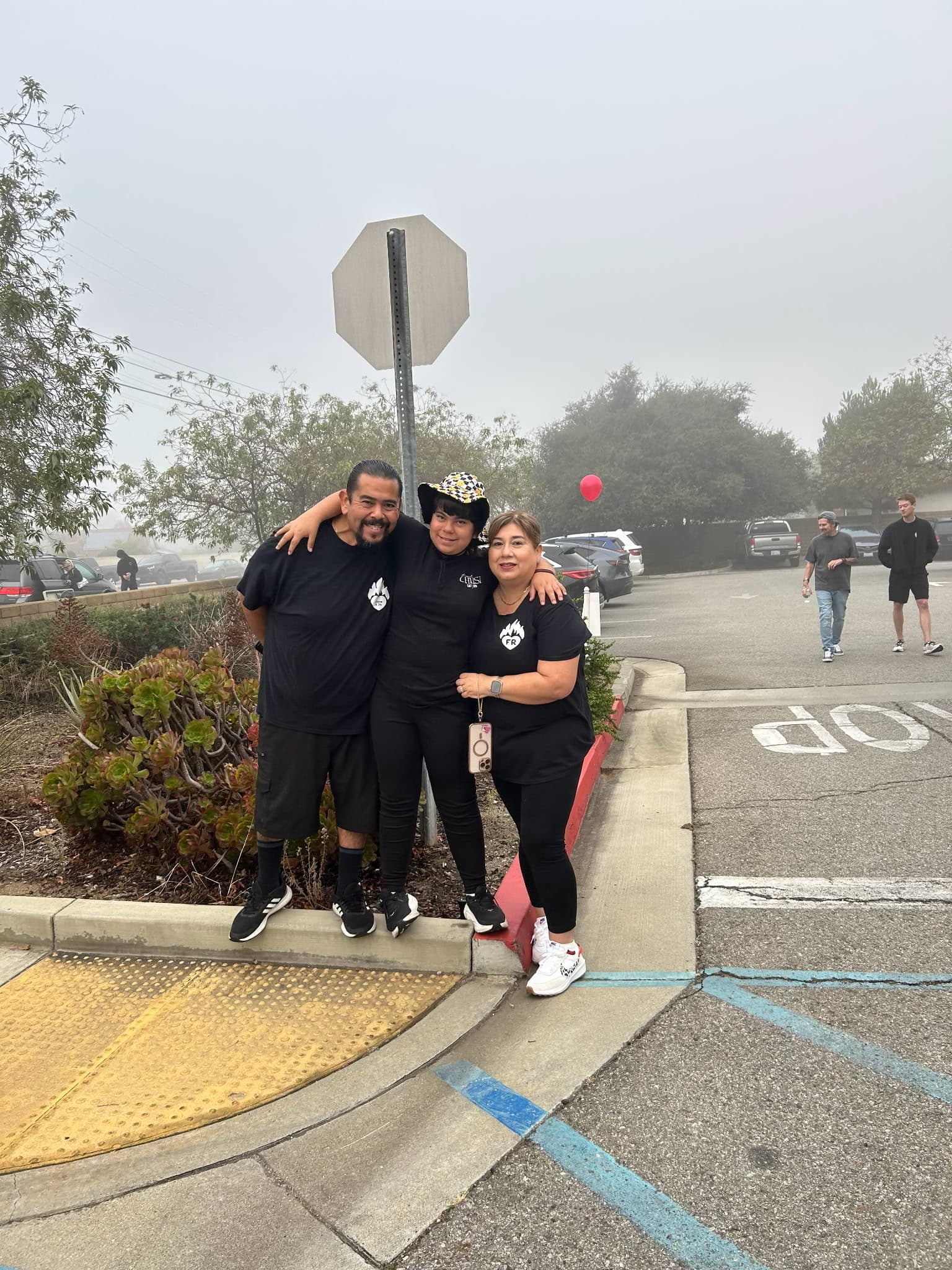 Family photo with three people wearing black shirts