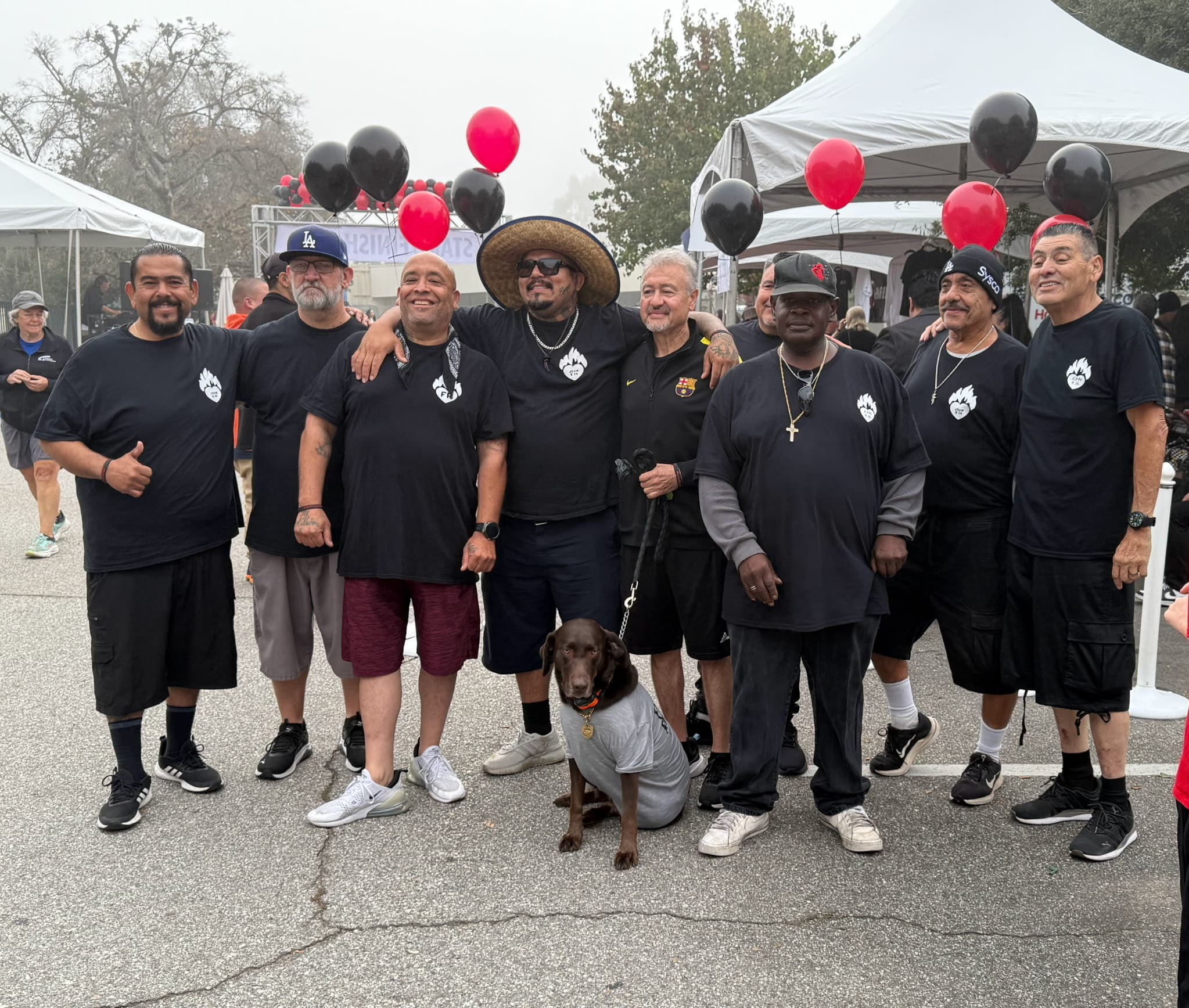 Group of ten men in recovery showing community support and fellowship