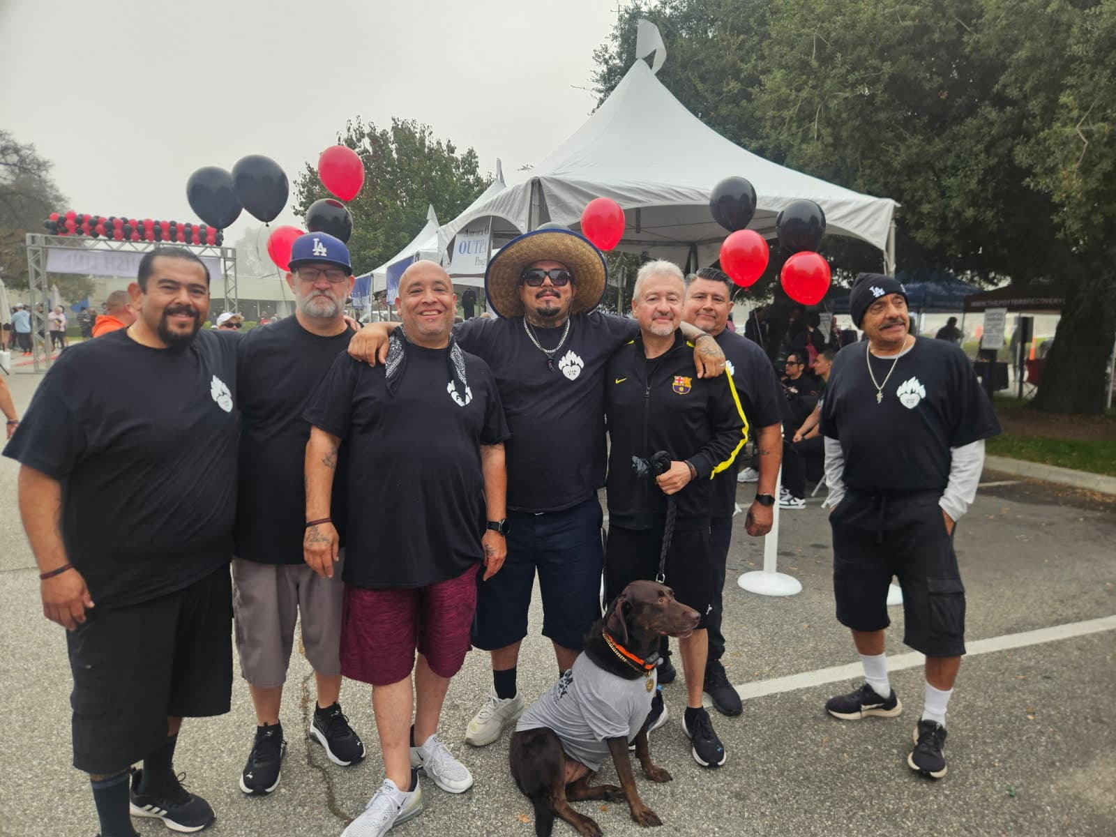 Group of men with dog at event